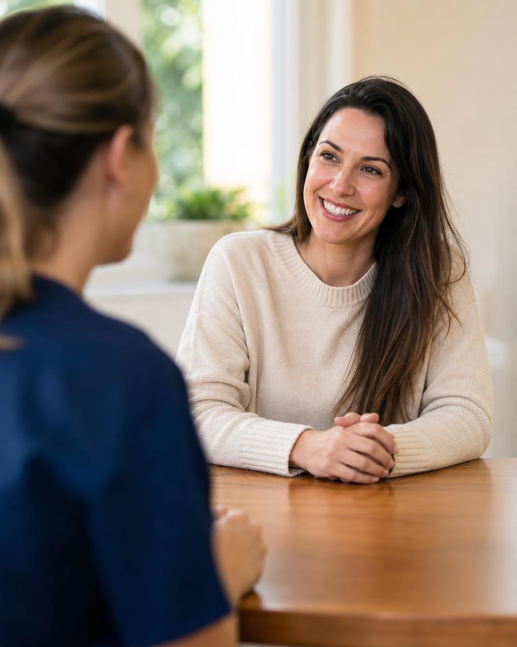 A patient and a team member talking across a desk during a friendly consultation at The Center for Dentistry of Vernon in Vernon Township, New Jersey